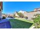 Artificial turf lawn, dining set, and built-in grill in this sunny backyard at 20508 W Carlton Mnr Mnr, Buckeye, AZ 85396