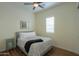 Cozy bedroom with a comfortable bed and wood floors at 20508 W Carlton Mnr Mnr, Buckeye, AZ 85396