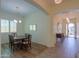 Formal dining room with hardwood floors, a dark wood table and chairs, and access to the entryway at 20508 W Carlton Mnr Mnr, Buckeye, AZ 85396