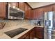 Stainless steel appliances and a stylish backsplash highlight this kitchen at 20508 W Carlton Mnr Mnr, Buckeye, AZ 85396