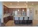 Well-equipped kitchen featuring an island, stainless steel appliances, and dark wood cabinets at 20508 W Carlton Mnr Mnr, Buckeye, AZ 85396