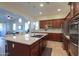 Spacious kitchen with center island, stainless steel appliances, and dark wood cabinetry at 20508 W Carlton Mnr Mnr, Buckeye, AZ 85396