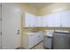 Bright laundry room with cabinets and sink at 20508 W Carlton Mnr Mnr, Buckeye, AZ 85396