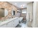 Elegant bathroom with double vanity, clawfoot tub, and exposed brick wall at 2111 W Mulberry Dr, Phoenix, AZ 85015