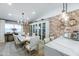 Elegant dining room featuring a rustic wooden table, chandelier, and exposed brick wall at 2111 W Mulberry Dr, Phoenix, AZ 85015