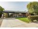 Charming brick home with a covered porch and spacious lawn at 2111 W Mulberry Dr, Phoenix, AZ 85015