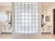 Elegant bathroom with a glass block wall separating vanities at 22432 N 48Th St, Phoenix, AZ 85054