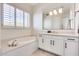 Elegant bathroom with soaking tub, walk-in shower, and double vanity at 22432 N 48Th St, Phoenix, AZ 85054