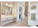 Bathroom featuring a large mirror, double sinks, and a walk-in shower at 22432 N 48Th St, Phoenix, AZ 85054