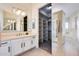 Bright bathroom with white cabinets, a large mirror, and walk-in closet at 22432 N 48Th St, Phoenix, AZ 85054