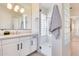 Bathroom with walk-in shower, glass block feature wall, and vanity at 22432 N 48Th St, Phoenix, AZ 85054