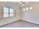 Well-lit bedroom featuring a window with shutters and ceiling fan at 22432 N 48Th St, Phoenix, AZ 85054