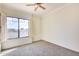 Spacious bedroom with large window, carpet flooring, and ceiling fan at 22432 N 48Th St, Phoenix, AZ 85054