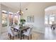 Bright dining room features a large table, chandelier, and view of flowering trees at 22432 N 48Th St, Phoenix, AZ 85054