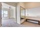 Bright hallway with mirrored wall and bench, leading to a bedroom with a view at 22432 N 48Th St, Phoenix, AZ 85054