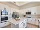 Modern kitchen with white cabinets, stainless steel appliances, and large island at 22432 N 48Th St, Phoenix, AZ 85054