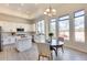 Spacious kitchen featuring white cabinets, island, and breakfast nook at 22432 N 48Th St, Phoenix, AZ 85054