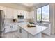 Modern kitchen with white cabinets, island, and stainless steel appliances at 22432 N 48Th St, Phoenix, AZ 85054