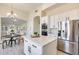 Modern kitchen with white cabinets, island, and stainless steel appliances at 22432 N 48Th St, Phoenix, AZ 85054