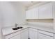 Laundry room with white cabinets and quartz countertops at 22432 N 48Th St, Phoenix, AZ 85054