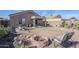 Landscaped backyard with a fire pit and patio furniture at 24191 N Desert Dr, Florence, AZ 85132