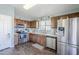 Modern kitchen with stainless steel appliances and wood cabinets at 24191 N Desert Dr, Florence, AZ 85132