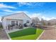 Relax in this backyard featuring a patio, string lights, trampoline, and faux grass at 2530 W Sable Ave, Apache Junction, AZ 85120