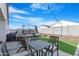 This backyard features a brick patio with seating, a fire pit, and a patch of artificial grass at 2530 W Sable Ave, Apache Junction, AZ 85120