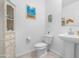 Compact, well-lit bathroom with a pedestal sink and a small cabinet for storage at 2530 W Sable Ave, Apache Junction, AZ 85120