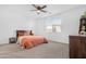 Relaxing bedroom with a ceiling fan, carpet flooring, and a large window with blinds allowing in natural light at 2530 W Sable Ave, Apache Junction, AZ 85120