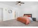 Cozy bedroom with a ceiling fan, carpeted floor, and neutral wall color and coordinated furnishings at 2530 W Sable Ave, Apache Junction, AZ 85120