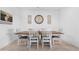 Dining room featuring a wooden table with white chairs, tile flooring, and decorative wall art at 2530 W Sable Ave, Apache Junction, AZ 85120