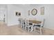 Dining area showcasing a farm-style table with white chairs, neutral decor, and a tile floor at 2530 W Sable Ave, Apache Junction, AZ 85120