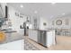 Well-lit kitchen featuring a granite island, white cabinets, stainless steel appliances, and access to the dining area at 2530 W Sable Ave, Apache Junction, AZ 85120