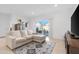 Comfortable living area with tile flooring, a sectional sofa, and a sliding glass door that leads to the patio at 2530 W Sable Ave, Apache Junction, AZ 85120