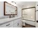 Updated bathroom with white vanity, quartz countertop and a tub at 2571 N Miller Rd, Scottsdale, AZ 85257