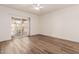 Spacious bedroom with wood-look flooring and sliding glass door to patio at 2571 N Miller Rd, Scottsdale, AZ 85257