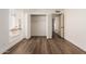 Well-lit bedroom with double door closet and wood-look flooring at 2571 N Miller Rd, Scottsdale, AZ 85257