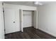 Bright bedroom featuring a ceiling fan, closet, and wood-look flooring at 2571 N Miller Rd, Scottsdale, AZ 85257