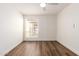 Light and airy bedroom with wood-look floors and window coverings at 2571 N Miller Rd, Scottsdale, AZ 85257