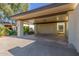 Covered carport with concrete flooring and access to the unit at 2571 N Miller Rd, Scottsdale, AZ 85257