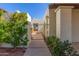 Inviting entryway with a wrought iron gate and lush landscaping at 2571 N Miller Rd, Scottsdale, AZ 85257