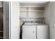 Convenient laundry area with washer, dryer, and shelving at 2571 N Miller Rd, Scottsdale, AZ 85257