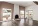 Living room with fireplace, patio access and wood flooring at 2571 N Miller Rd, Scottsdale, AZ 85257