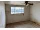 Large bedroom with ceiling fan and window at 2613 E Lynne Ln, Phoenix, AZ 85042