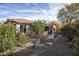 Landscaped backyard with fire pit, patio, and mature trees at 26293 W Sierra Pinta Dr, Buckeye, AZ 85396