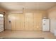 Garage featuring built-in storage and a mini fridge at 26293 W Sierra Pinta Dr, Buckeye, AZ 85396