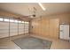 Garage with built-in cabinets, a large door, and a rug at 26293 W Sierra Pinta Dr, Buckeye, AZ 85396