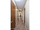 Long hallway with tile floors and access to bedrooms at 26293 W Sierra Pinta Dr, Buckeye, AZ 85396