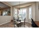 Bright kitchen nook with glass table and wrought iron chairs at 26293 W Sierra Pinta Dr, Buckeye, AZ 85396